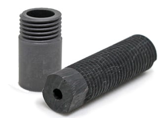 A closeup of two ceramic parts for aerospace & defense use