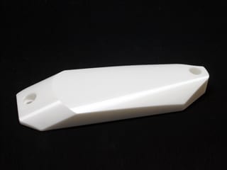 A closeup of a machined ceramic part with many sharp angles